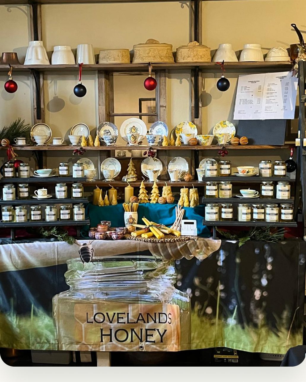 The Lovelands Honey display of jars, beeswax candles and vintage china at the family farm