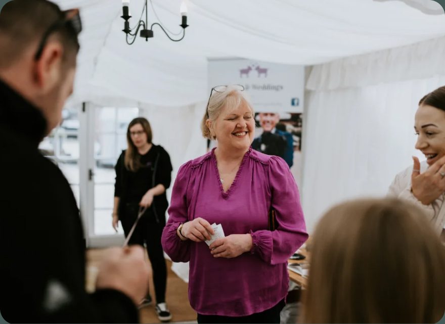 Laura talking with customers at a Lovelands Honey event