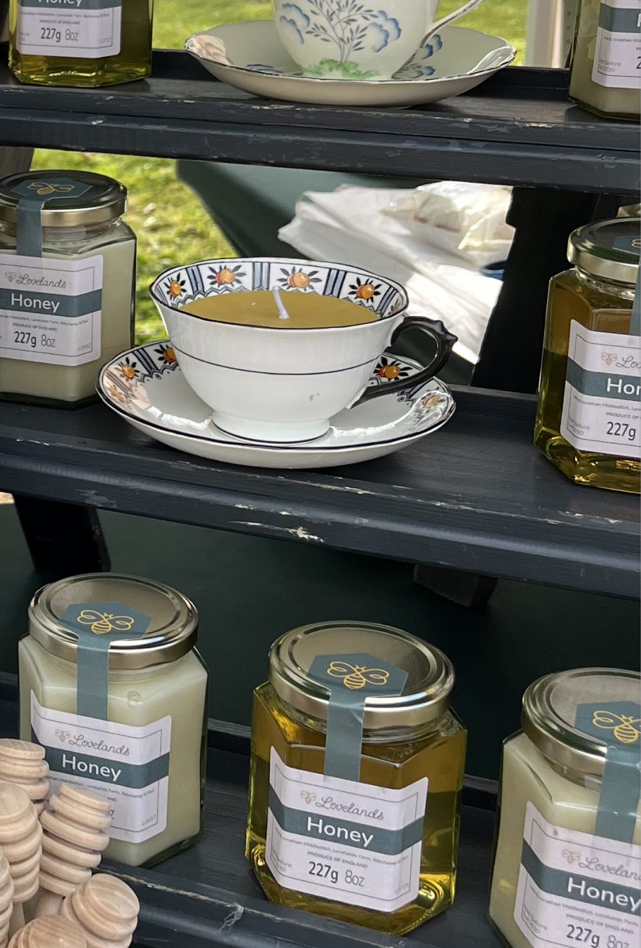 Jars of Lovelands honey and a teacup of honey on the market stall