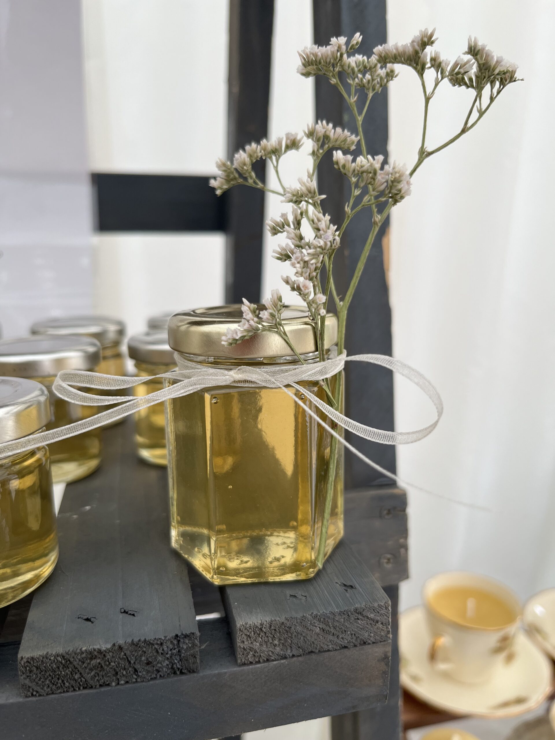 A jar of Lovelands honey styled with dried flowers